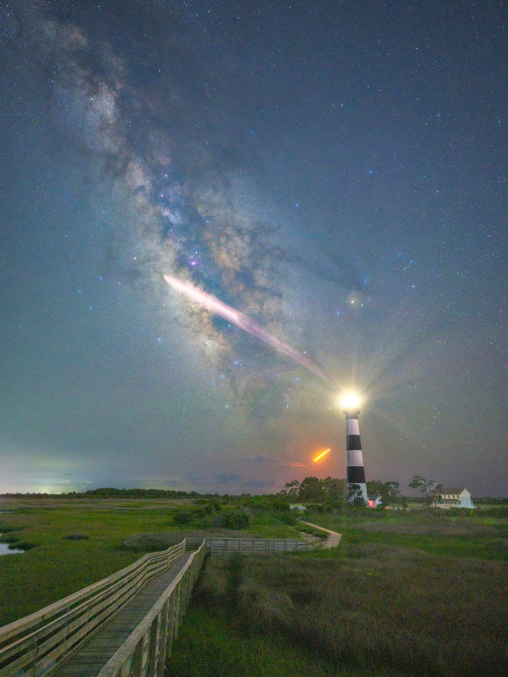 Taylor Brantley's photograph of the Milky Way and a rocket launch above Bodie Island Lighthouse